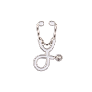 Close-up of a silver medical stethoscope brooch with white enamel detail on a white background