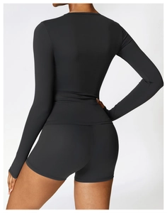 Back view of black high-stretch long sleeve yoga top and fitted shorts fitness set