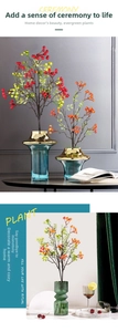 Artistic glass vase with colorful artificial red berry stems for modern home decor