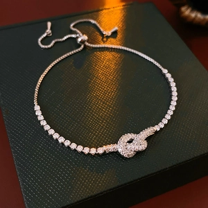 Detailed macro of silver-plated knot bracelet featuring sparkling cubic zirconia stones