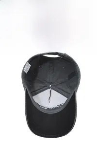 Detail view of internal stitching and metal adjustment buckle on washed grey baseball cap