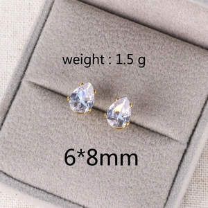 Detailed view of pear-cut zircon earrings in gold frame with 6x8mm size and 1.5g weight