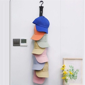 Detail of vertical black fabric cap organizer showing multiple hooks for baseball hats