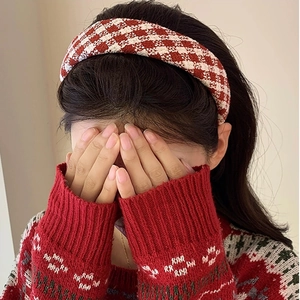 Detail of red and white plaid wool headband on a model for a vintage autumn style