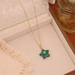 Elegant gold star pendant necklace with green malachite texture and blue center stone