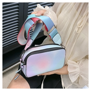Close-up of vibrant gradient camera bag with dual zippers and matching wide shoulder strap