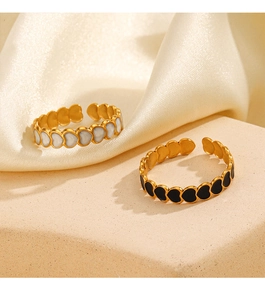 Detail of 18K gold-plated heart-shaped open rings with white shell and black enamel inlay