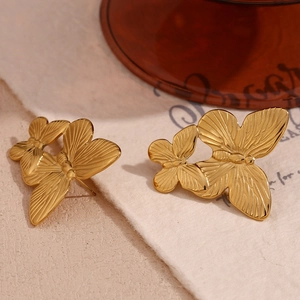 Detail of 18K gold plated double butterfly earrings with fine radial texture