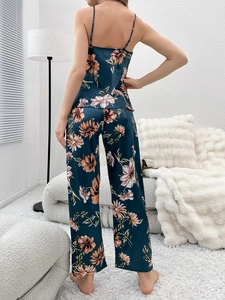 Detail view of silky navy blue floral pajama set featuring a camisole and straight trousers