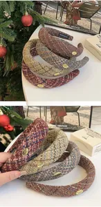 Close-up of vintage plaid tweed headband with gold metal tag in a cozy winter setting