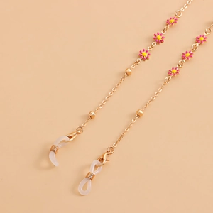 Detail of gold eyewear chain with pink and yellow enamel flowers and silicone loops