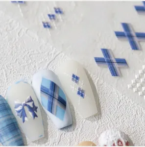 Detail of 5D embossed nail stickers featuring blue plaid and 3D bow tie patterns