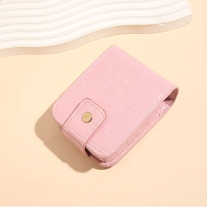 Detail of pink crocodile pattern PU leather lipstick case with gold metal clasp and mirror