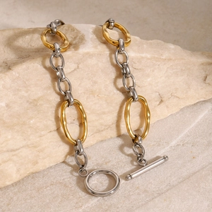 Two-tone stainless steel chain bracelet with gold and silver links and toggle clasp