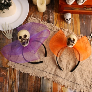 Halloween headband with purple and orange skull mesh design on rustic wood background