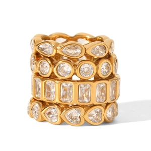 Gold plated ring set with heart and pear shaped cubic zirconia stones on white background