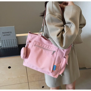 Pink large capacity canvas tote bag with small round coin purse shown on female model