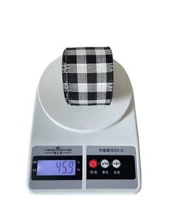 Weight measurement of black and white checkered ribbon roll showing 45.9g on scale
