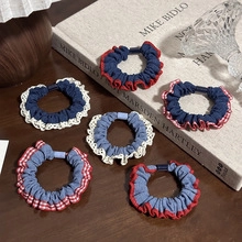 Detail of candy color seamless hair ties with lace and plaid edges on a wooden table