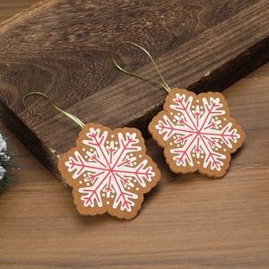 Close-up of snowflake Christmas ornaments with red and white patterns on wooden background
