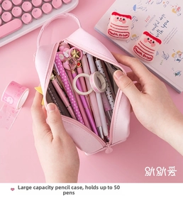 Top view of pink canvas pencil case with large capacity compartments for 50 pens