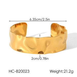 Detail view of gold wavy textured open cuff bracelet showing diameter and width dimensions