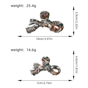 Size guide for acetate bow hair claws showing dimensions in cm and inches for two sizes