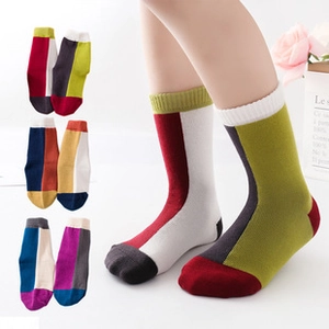 Detailed close-up of ribbed cuffs on color-block cotton socks for girls