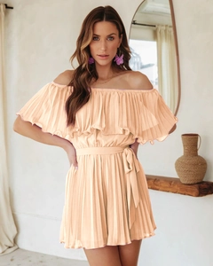 Detail of apricot off-shoulder pleated romper with ruffle neckline and waist tie detail