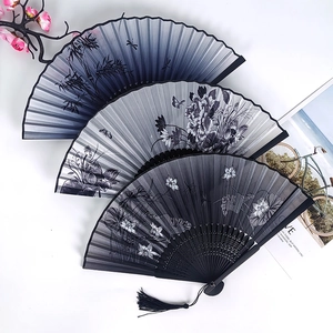 Three Chinese folding fans with ink painting patterns of bamboo and flowers on white background
