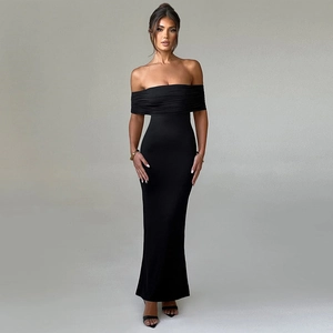 Close-up detail of the backless design and slim fit of this black strapless maxi dress
