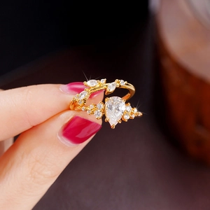 Macro shot of gold branch ring with pear-shaped zircon and marquise stones