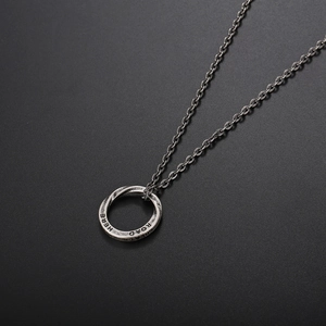 Vintage Mobius silver titanium steel necklace with engraved Road Here pendant on black backdrop