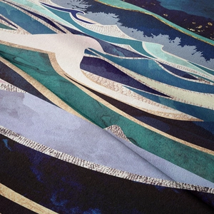Close-up detail of soft abstract mountain tapestry with blue and gold marble texture