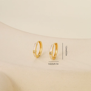 Detail view of gold zircon earrings with dimensions of 1.2cm height and 0.2cm width