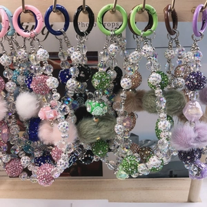 Detailed display of colorful Nepal-style beaded phone straps with fuzzy charms and crystals