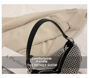 Detail of silver rhinestone handbag showing crystal mesh texture and black leather handle