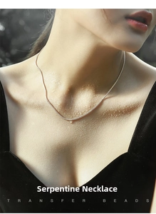 Close-up of minimalist S925 sterling silver snake chain on skin with water droplets