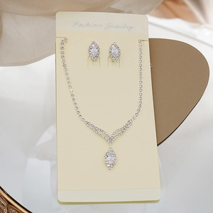 Macro shot of silver bridal jewelry set with marquise-cut marquise zircon tassels
