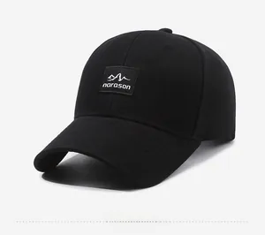 Side view of black cotton baseball cap with embroidered mountain logo patch