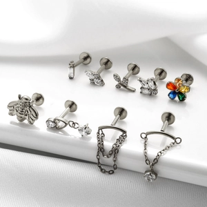 G23 titanium labret studs with colorful zircon and chain tassels on white background