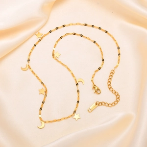 Collier élégant en acier inoxydable doré avec étoiles et lunes sur soie champagne