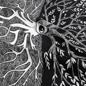 Detail of artistic tree of life tapestry showing intricate black and white spiral patterns