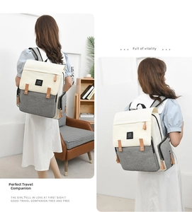 Detail view of the large capacity diaper backpack in cream and grey with leather accents