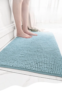 Close-up of blue chenille bath mat showing thick absorbent microfiber pile and texture