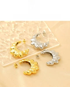 Detail of croissant dome earrings showing 18K vacuum plating in gold and silver
