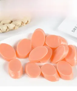 Close-up of realistic PVC ham slices with glossy texture on a white decorative plate