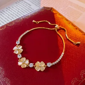 Elegant gold flower bracelet with cat eye stones and sparkling cubic zirconia stones