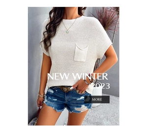 Detail view of the cream white knitted short sleeve top with front pocket and round neck