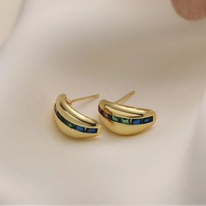 18K gold plated C-shaped star earrings with colorful zircon gems on silk background